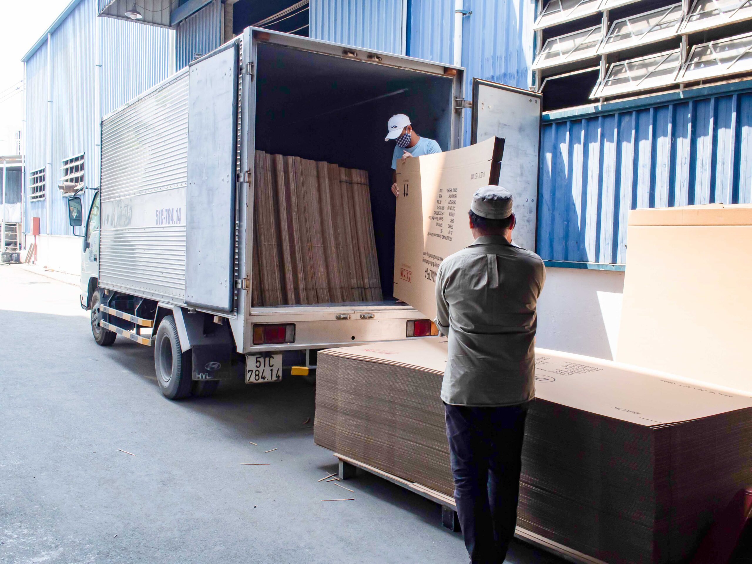 Workers loading goods into delivery truck